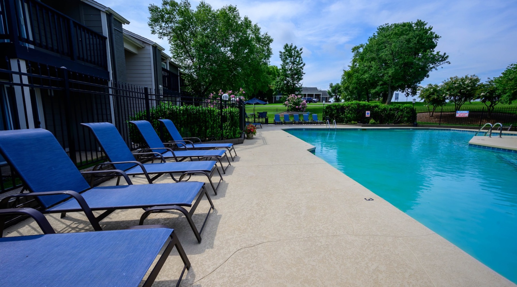 a pool with chairs around it