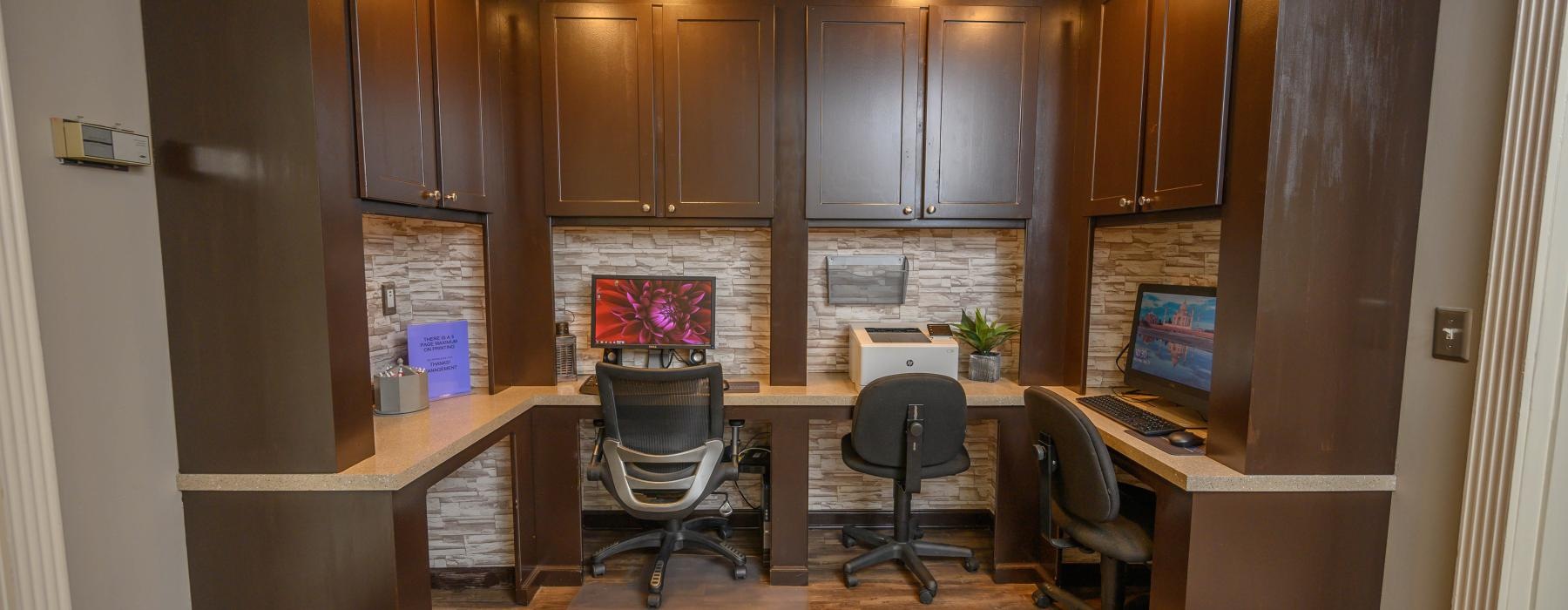 a room with a desk and chairs