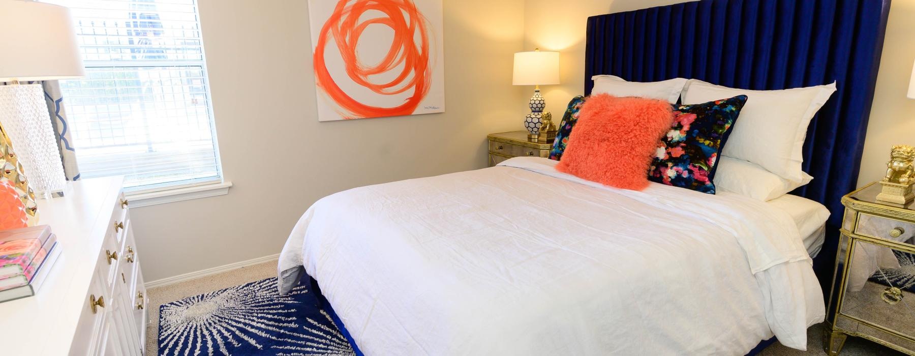 a bedroom with a bed and lamps