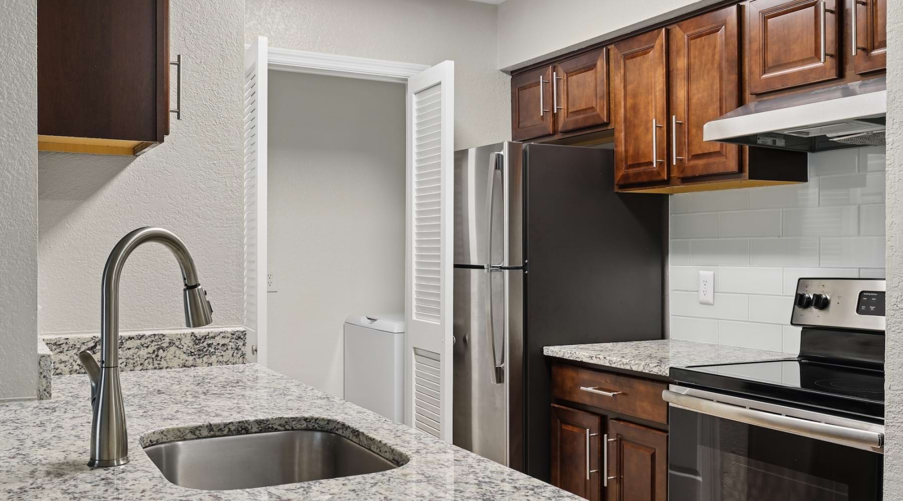 kitchen with wood cabinets and quartz countertops
