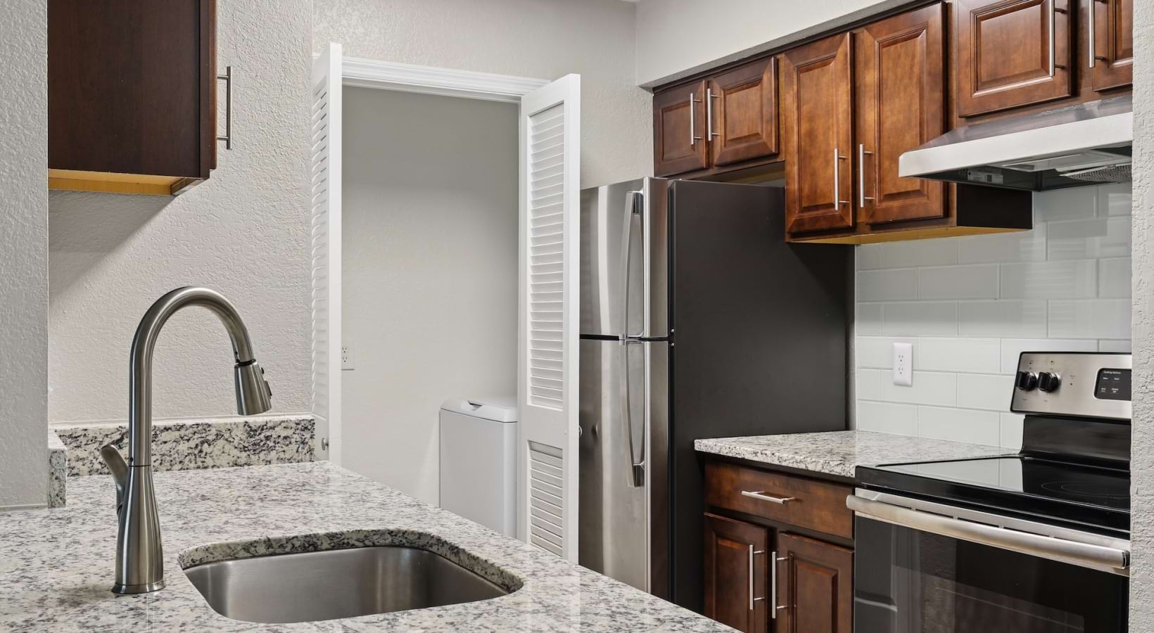 kitchen with wood cabinets and quartz countertops