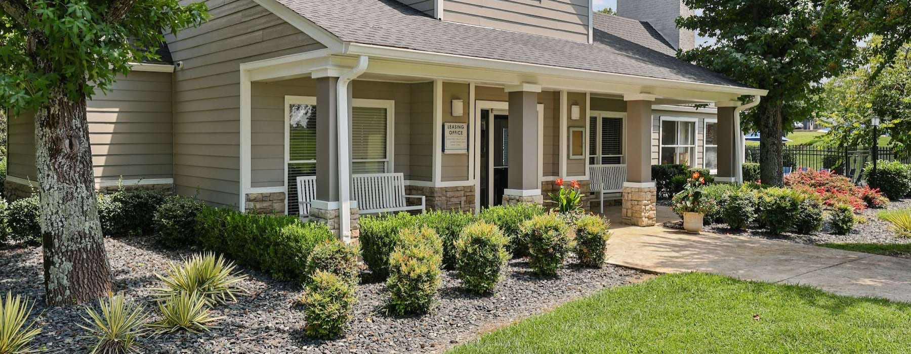 a leasing office with lush landscaping